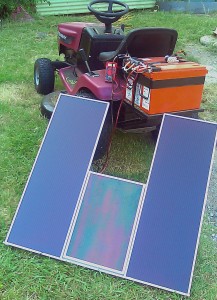 An array of solar panels, charging the 36 volt battery of a lawnmower